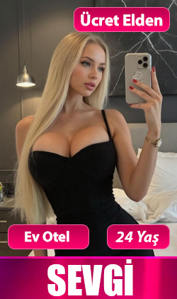 İzmir escort sarışın kadın, beyaz gömlek rahat iç mekan pozu